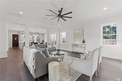 Open concept living room with hardwood floors, recessed lighting, modern ceiling fan, and white walls